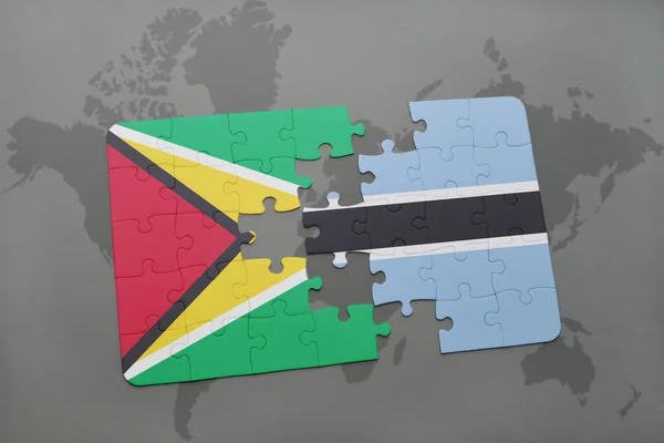 Rompecabezas con la bandera nacional de Guayana y Botswana en un mapa del mundo — Foto de Stock