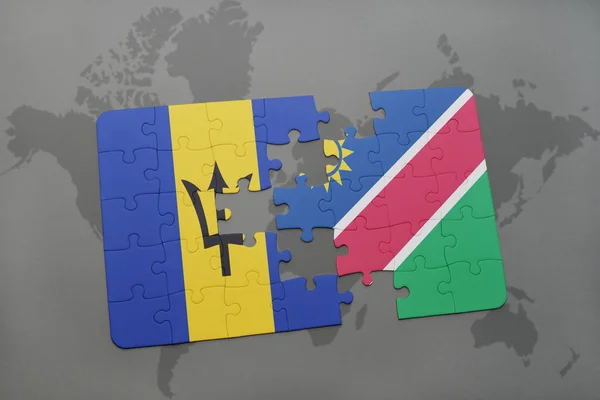 Rompecabezas con la bandera nacional de barbados y namibia en un mapa del mundo — Foto de Stock