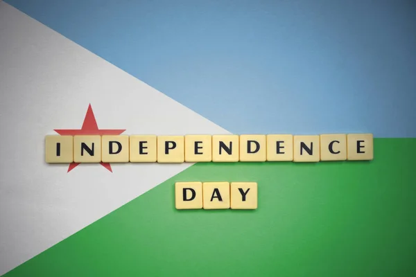 Letters with text independence day on the national flag of djibouti. — Stock Photo, Image