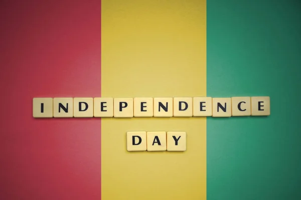 Letters with text independence day on the national flag of guinea. — Stock Photo, Image