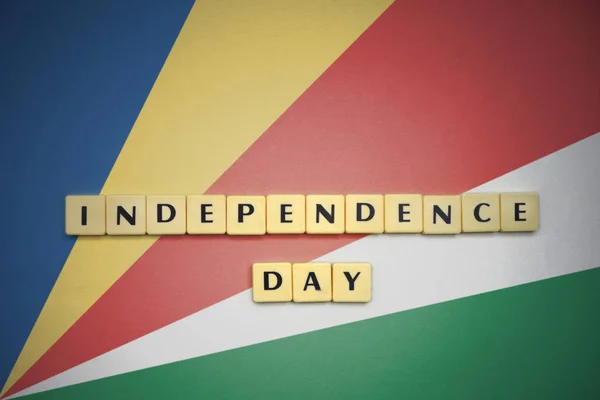 Letters with text independence day on the national flag of seychelles. — Stock Photo, Image