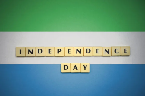 Letters with text independence day on the national flag of sierra leone. — Stock Photo, Image