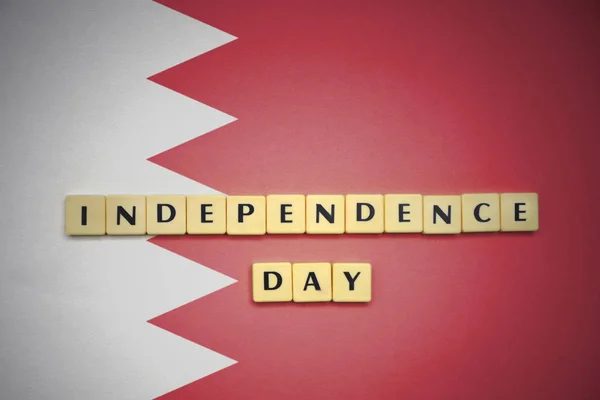 Cartas con el texto día de la independencia en la bandera nacional de Bahréin . —  Fotos de Stock
