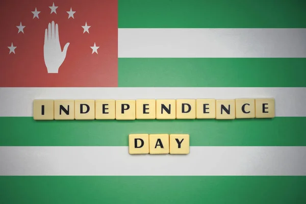 Letters with text independence day on the national flag of abkhazia. — Stock Photo, Image