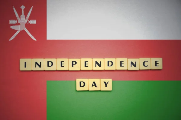 Letters with text independence day on the national flag of oman. — Stock Photo, Image