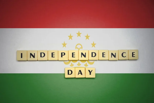Letters with text independence day on the national flag of tajikistan. — Stock Photo, Image