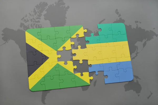 Rompecabezas con la bandera nacional de jamaica y gabón en un mapa del mundo — Foto de Stock