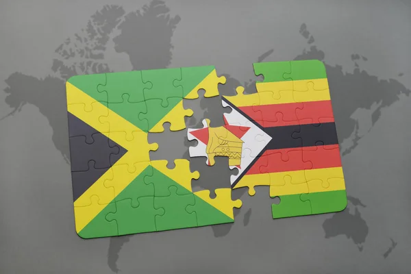 Rompecabezas con la bandera nacional de jamaica y zimbabwe en un mapa del mundo — Foto de Stock