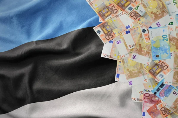 Euro money banknotes on the waving national flag of estonia. — Stock Photo, Image