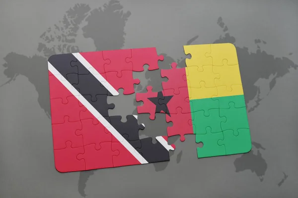 Rompecabezas con la bandera nacional de trinidad y tobago y bissau guinea en un mapa del mundo — Foto de Stock