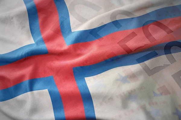 Kleurrijke wapperende vlag van de Faeröer op een euro geld bankbiljetten achtergrond. — Stockfoto
