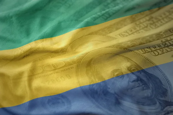 Colorful waving national flag of gabon on a american dollar money background. — Stock Photo, Image