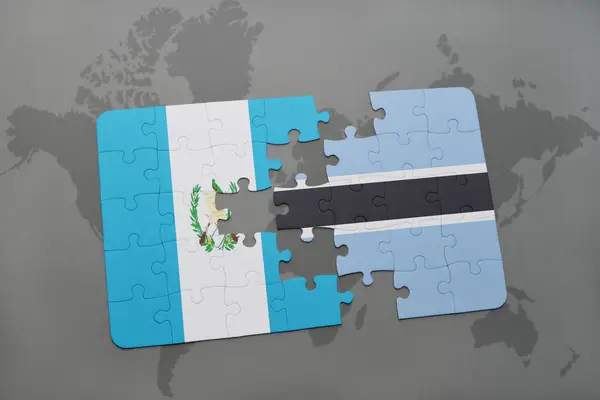 Puzzle with the national flag of guatemala and botswana on a world map — Stock Photo, Image