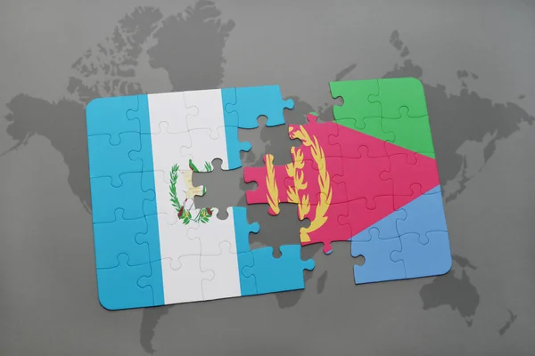 Puzzle with the national flag of guatemala and eritrea on a world map — Stock Photo, Image