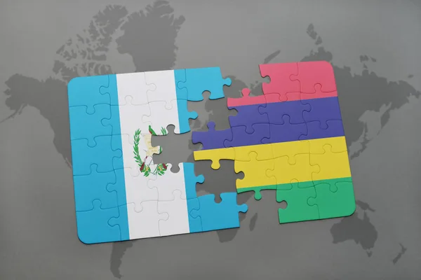 A nemzeti zászló, guatemala és mauritius egy világtérképen puzzle — Stock Fotó