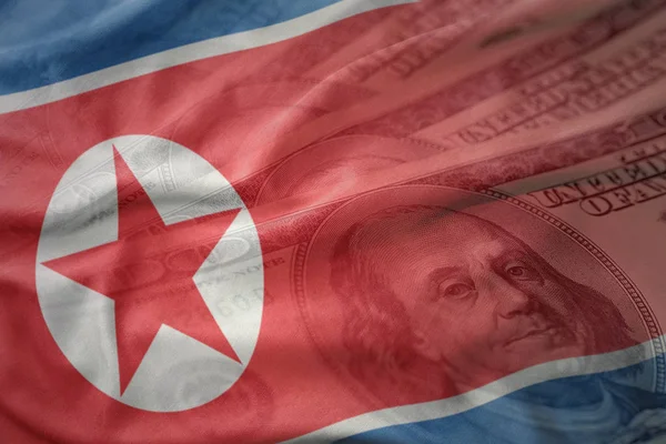 カラフルなアメリカのドルの金の背景に北朝鮮の国旗を振っています。財務の概念 — ストック写真