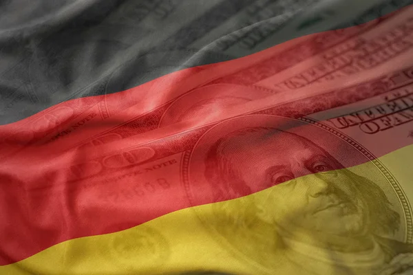 Coloré agitant drapeau national de l'Allemagne sur un fond d'argent dollar américain. concept de financement — Photo