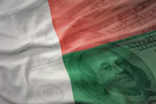 Colorido acenando bandeira nacional de madagascar em um fundo de dinheiro dólar americano. conceito de financiamento — Fotografia de Stock