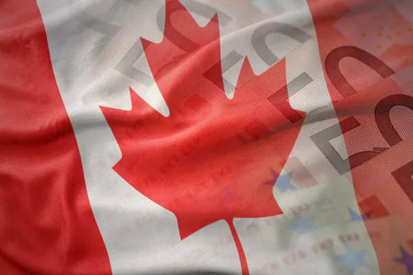 Colorido ondeando bandera nacional de Canadá sobre un fondo de billetes de dinero en euros. concepto de financiación —  Fotos de Stock