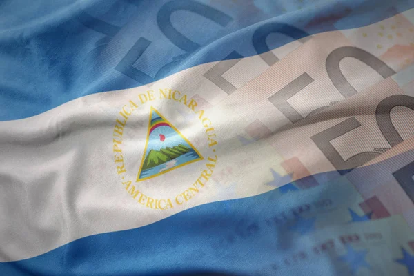 Kleurrijke wapperende vlag van nicaragua op een euro geld bankbiljetten achtergrond. Financiën concept — Stockfoto