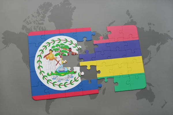 Puzzle mit der Nationalflagge von Belize und Mauritius auf einer Weltkarte — Stockfoto