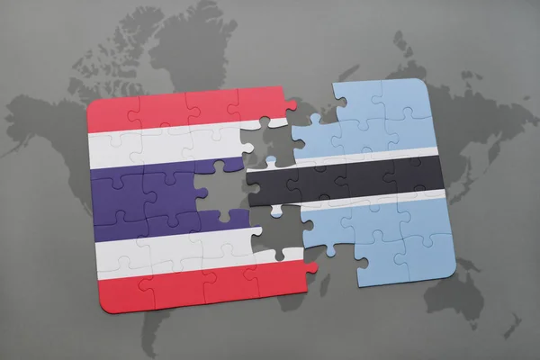 Puzzle con la bandiera nazionale della Thailandia e del Botswana su una mappa del mondo — Foto Stock