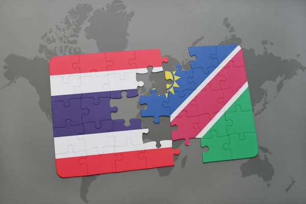 Quebra-cabeça com a bandeira nacional de Tailândia e Namíbia em um mapa do mundo — Fotografia de Stock