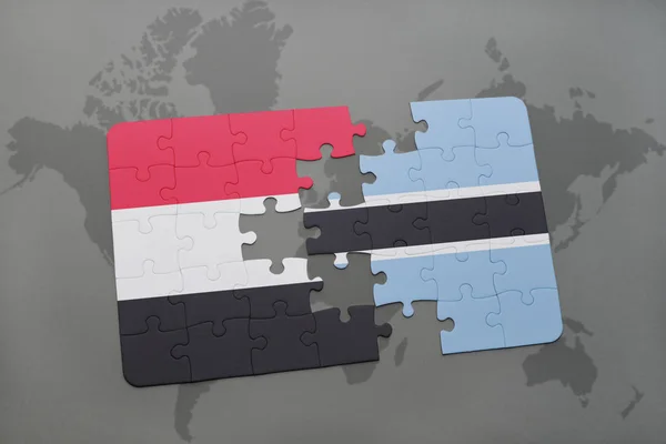 Quebra-cabeça com a bandeira nacional do Iêmen e Botswana em um mapa mundial — Fotografia de Stock
