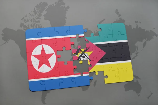 Puzzle with the national flag of north korea and mozambique on a world map — Stock Photo, Image