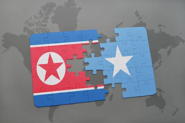 Puzzle with the national flag of north korea and somalia on a world map — Stock Photo, Image