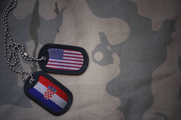 Army blank, dog tag with flag of united states of america and croatia on the khaki texture background. military concept — Stock Photo, Image