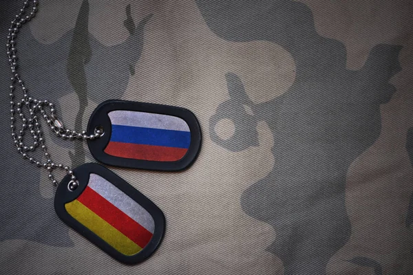 Армія порожнім, собака тег з прапором Росії та Південною Осетією, на тлі хакі текстури. Військова концепція — стокове фото