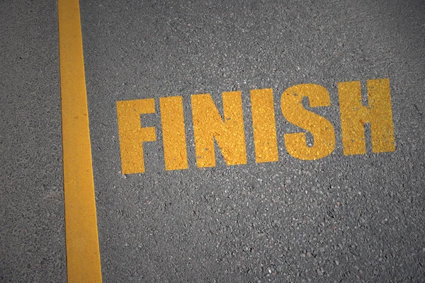 asphalt road with text finish near yellow line