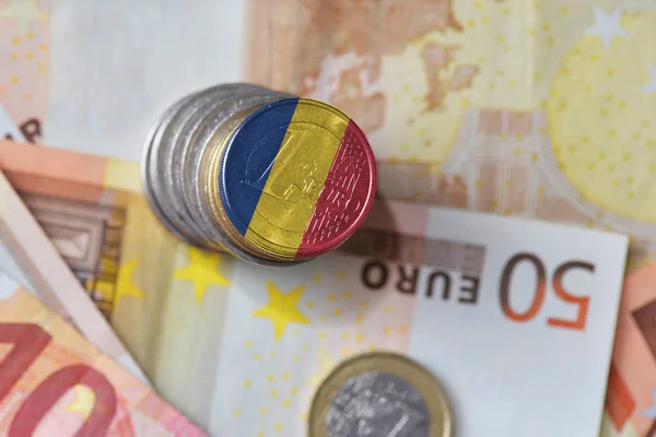 Euro coin with national flag of romania on the euro money banknotes background. — Stock Photo, Image