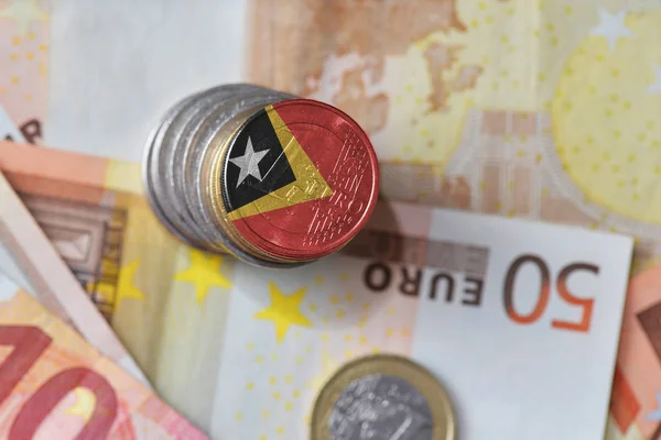 Euro coin with national flag of east timor on the euro money banknotes background. — Stock Photo, Image