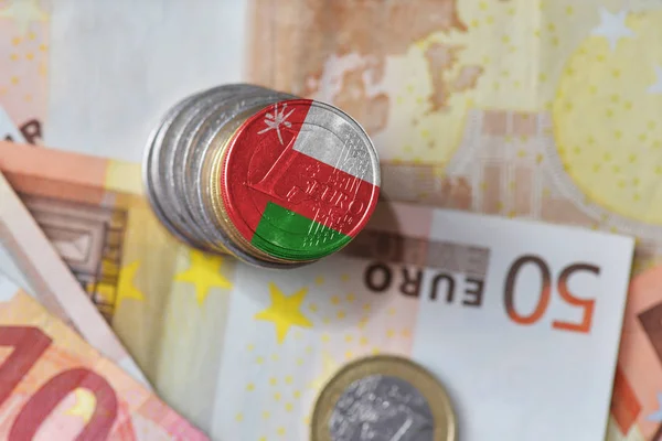 Euro coin with national flag of oman on the euro money banknotes background. — Stock Photo, Image