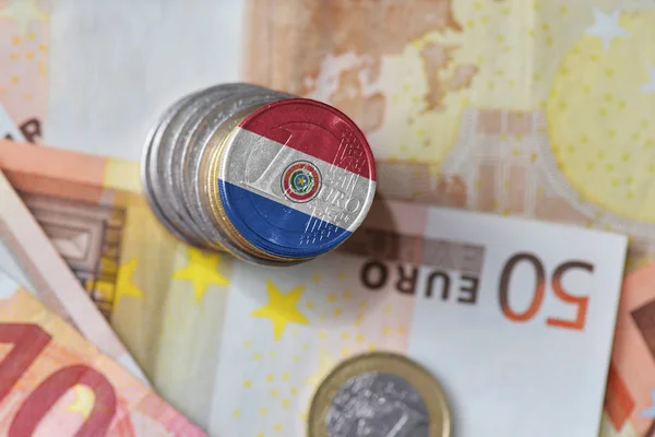 Euro coin with national flag of paraguay on the euro money banknotes background. — Stock Photo, Image