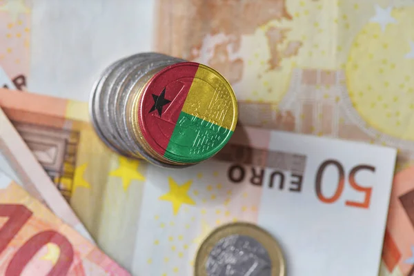 Euro coin with national flag of guinea bissau on the euro money banknotes background. — Stock Photo, Image