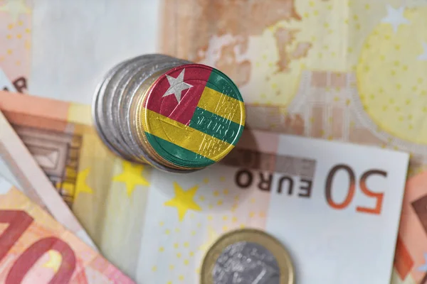 Euro coin with national flag of togo on the euro money banknotes background. — Stock Photo, Image
