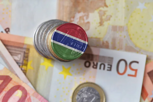 Euro coin with national flag of gambia on the euro money banknotes background. — Stock Photo, Image