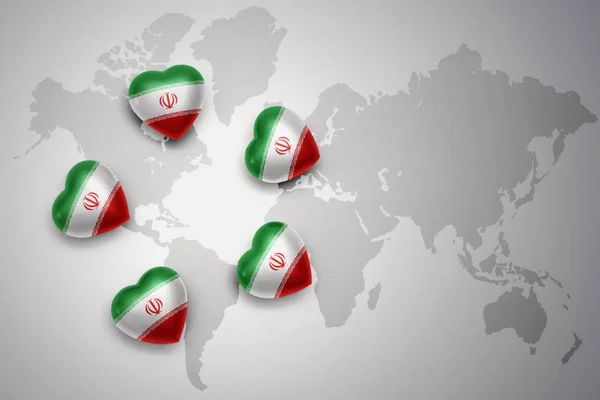 Cinque cuori con bandiera nazionale di iran sullo sfondo di una mappa del mondo . — Foto Stock
