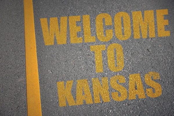 Asphalt road with text welcome to kansas near yellow line. — Stock Photo, Image