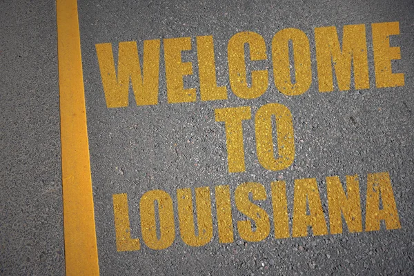 Asphalt road with text welcome to louisiana near yellow line. — Stock Photo, Image