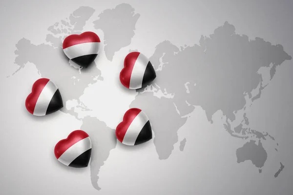 Five hearts with national flag of yemen on a world map background. — Stock Photo, Image