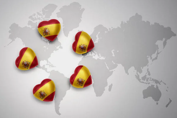 Five hearts with national flag of spain on a world map background. — Stock Photo, Image