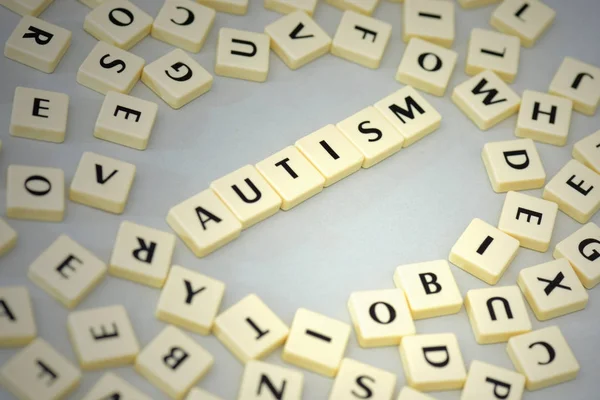 Text autism on the gray background near the letters. Royalty Free Stock Photos