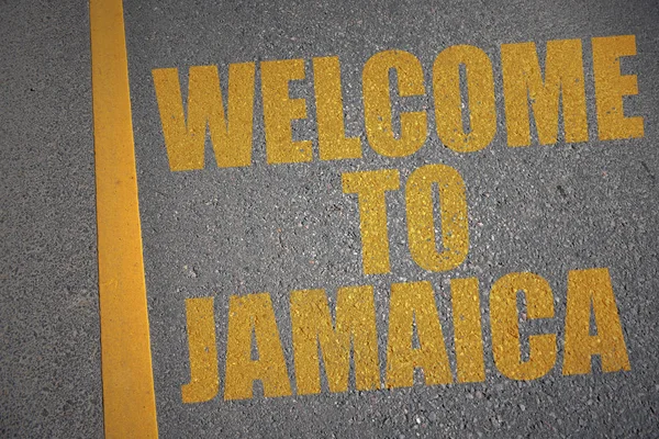 Asphalt road with text welcome to jamaica near yellow line. — Stock Photo, Image