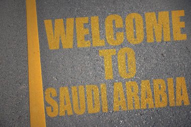 asfalt yol ile metin sarı no'lu satırın yakınında Suudi Arabistan'a hoş geldiniz. kavramı