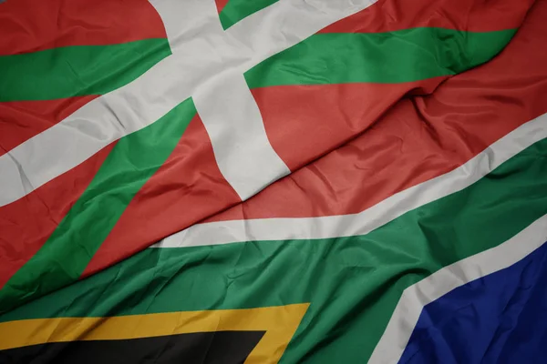 南アフリカのカラフルな旗やバスク地方の国旗を振って. — ストック写真