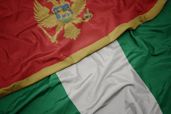 Zwaaiende vlag van nigeria en nationale vlag van montenegro. — Stockfoto